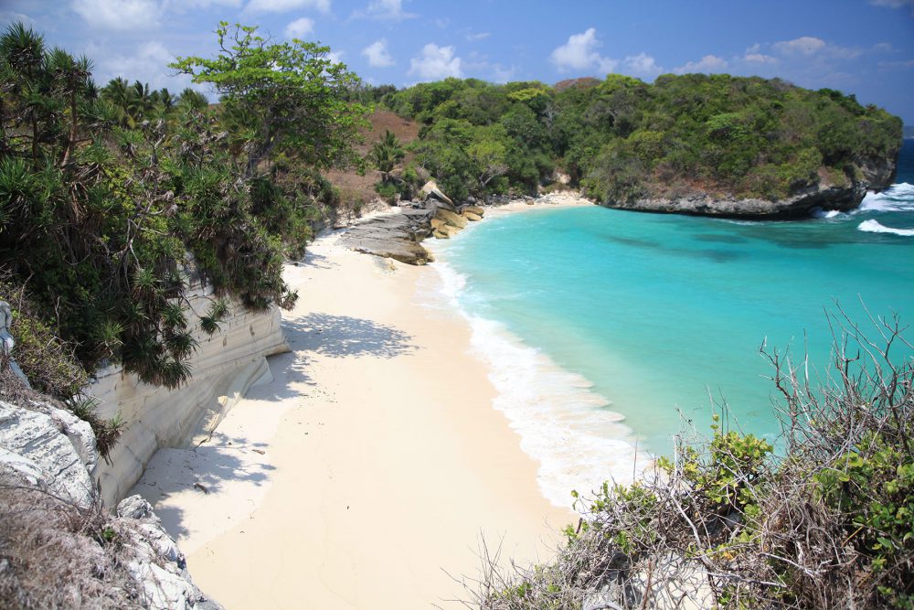 beaches in sumba - beautiful clear preserved ocean in sumba surf camp